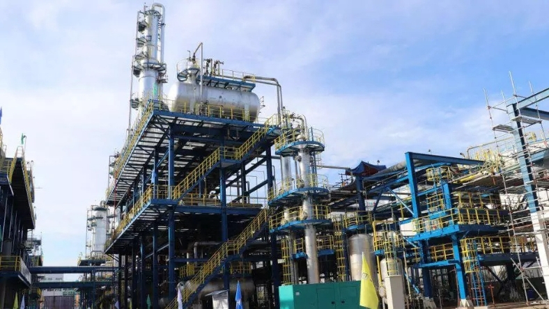 Industrial processing facility with multi-level steel framework and piping