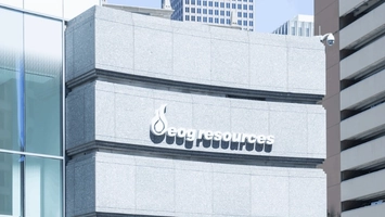 EOG Resources office building with raised white lettering and flame logo on a light grey stone exterior facade